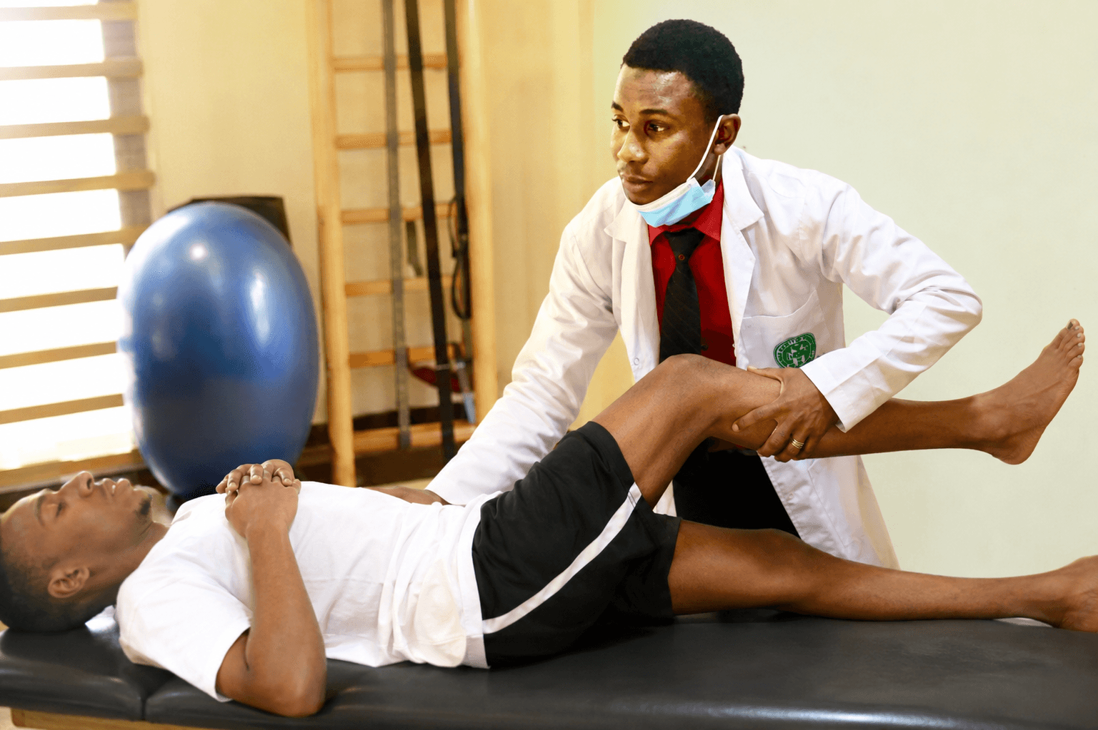 Physiotherapist helping a patient with rehabilitation